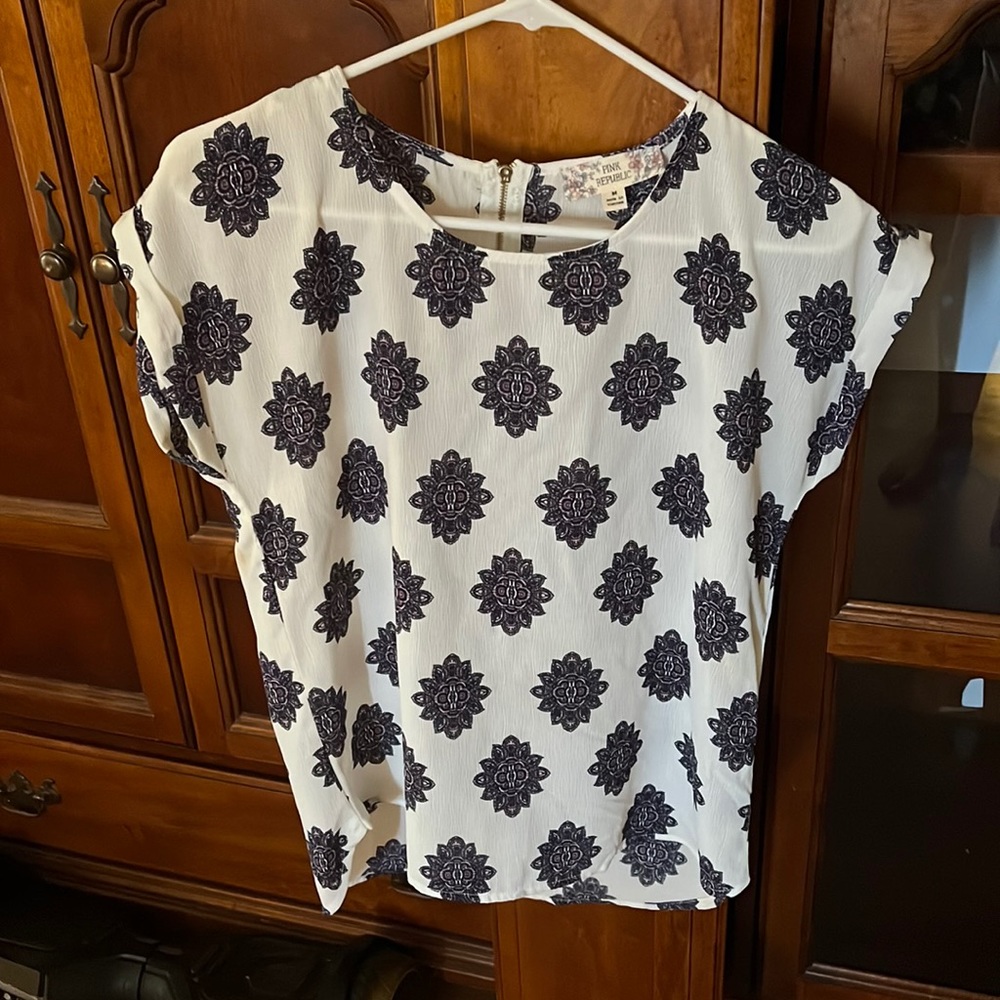 Women’s size medium blouse for $10 never worn but without tags.